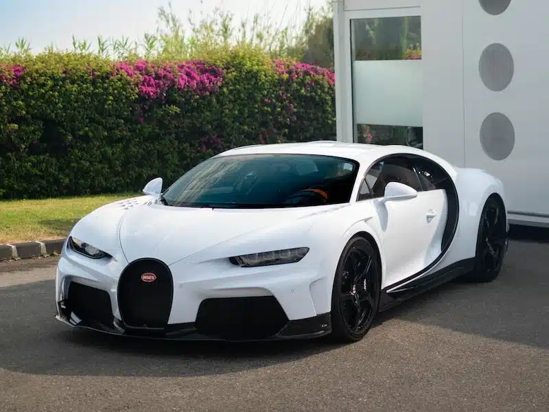 white lamborghini aventador parked near white concrete building during daytime